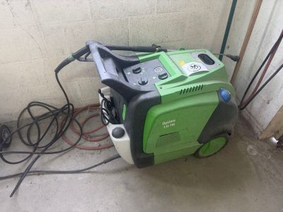 a green and black generator in the corner of a room