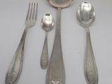 a spoon, fork, and spoon rest on a table