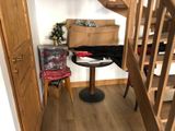 a small table and chair in the corner of a room