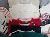 a lot of clothes that are sitting on the floor