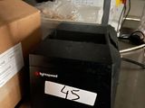 a black box sitting on top of a counter next to a box