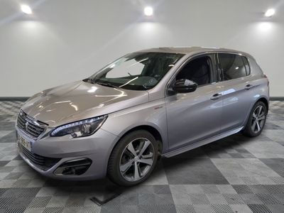 the silver car is parked on a checkered floor in the garage