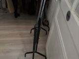 a picture of a closet with clothes on hangers and clothes on racks
