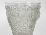 a glass vase that has a flower design on it