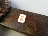 a close up of a wooden bench with a sticker on it