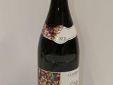 a bottle of red wine with sprinkles on it