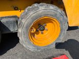 a yellow wheel on the back of a construction vehicle