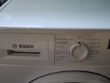 a white washing machine sitting on top of a counter