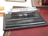 a pen that is sitting on top of a leather case