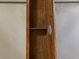 a grandfather clock that is sitting on a wooden stand