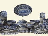 a group of blue and white plates and bowls on a table