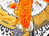 a picture of an orange and black scarf with a picture of an elephant