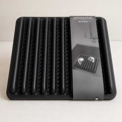 a black tray that has a bunch of food inside of it