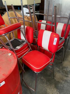 several red and white chairs are lined up in a room