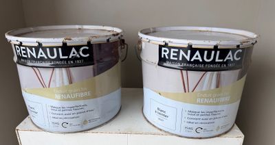 two buckets of paint sitting on top of a box