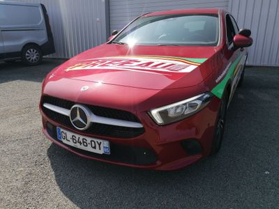 a red car that is parked in front of a building