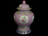 a purple vase with a lid on a black background