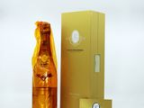 a bottle of champagne sitting next to a gold box
