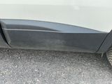 a close up of the side of a white car