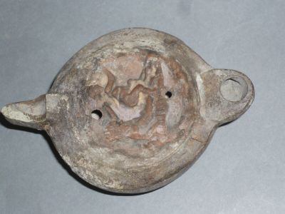 a clay pot that has a picture of a man in a boat on it