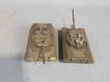 two toy tanks that are sitting on a table