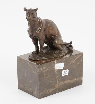 bronze sculpture of a cat sitting on a marble block