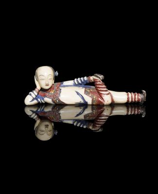 an image of a figurine of a woman laying on her stomach
