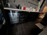 an image of a kitchen with a refrigerator and a counter