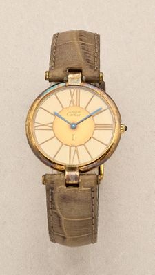 a gold watch with a blue second hand