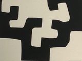 a black and white picture of a cross on a wall