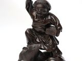 bronze figurine of a boy with a dog and a bowl of water