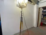 a lamp that is on a tripod in a room