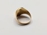 a close up of a gold ring on a white surface