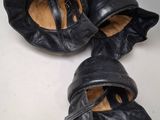 a pair of black shoes that are on a table