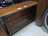 a bike that is parked next to a wooden cabinet