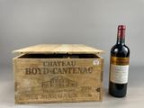an old wooden box with a bottle of wine next to it