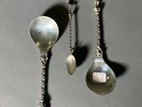 two spoons and a spoon spoon on a table