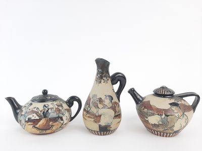 three teapots that are sitting on a white surface