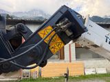 a construction machine that is working on a building