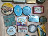 many different tins on the floor and one has a clock