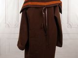 an image of a coat on a mannequin stand in a room