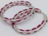 pair of silver and pink enamel hoop earrings on a white background