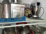 many pots and pans on the shelves in the kitchen