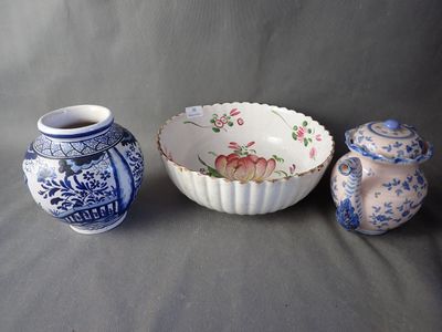 three vases and a bowl sitting on a table