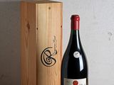 a bottle of wine sitting next to a wooden box