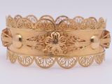 an image of a close up of a gold bracelet
