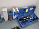 a blue case with tools in it sitting on the floor