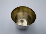 an antique silver bowl on a white surface