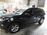 a picture of a black car parked in a garage