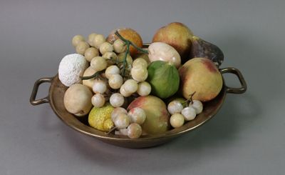 a bowl of fruit that is sitting on a table